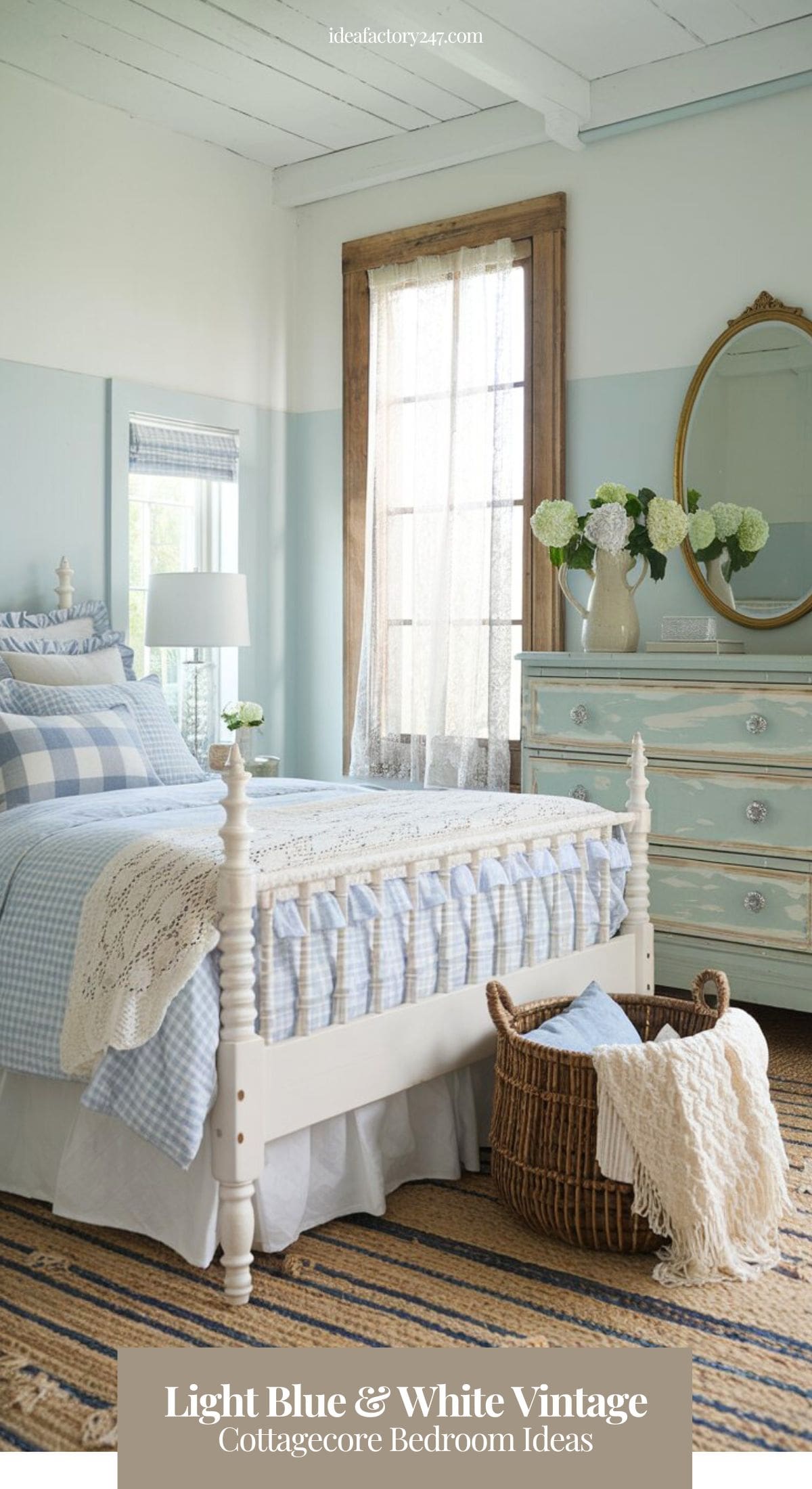 A charming cottage-style bedroom with soft robin’s egg blue walls and a white wooden bedframe with spindle detailing. The bed is dressed in white and blue gingham bedding, ruffled pillow shams, and a handwoven lace throw blanket. A large distressed wooden dresser with crystal knobs sits against the wall, topped with a ceramic pitcher of fresh-cut hydrangeas and a brass-framed oval mirror.
