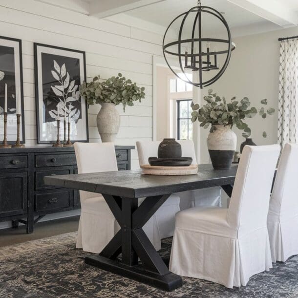 A modern farmhouse dining room in black and white.