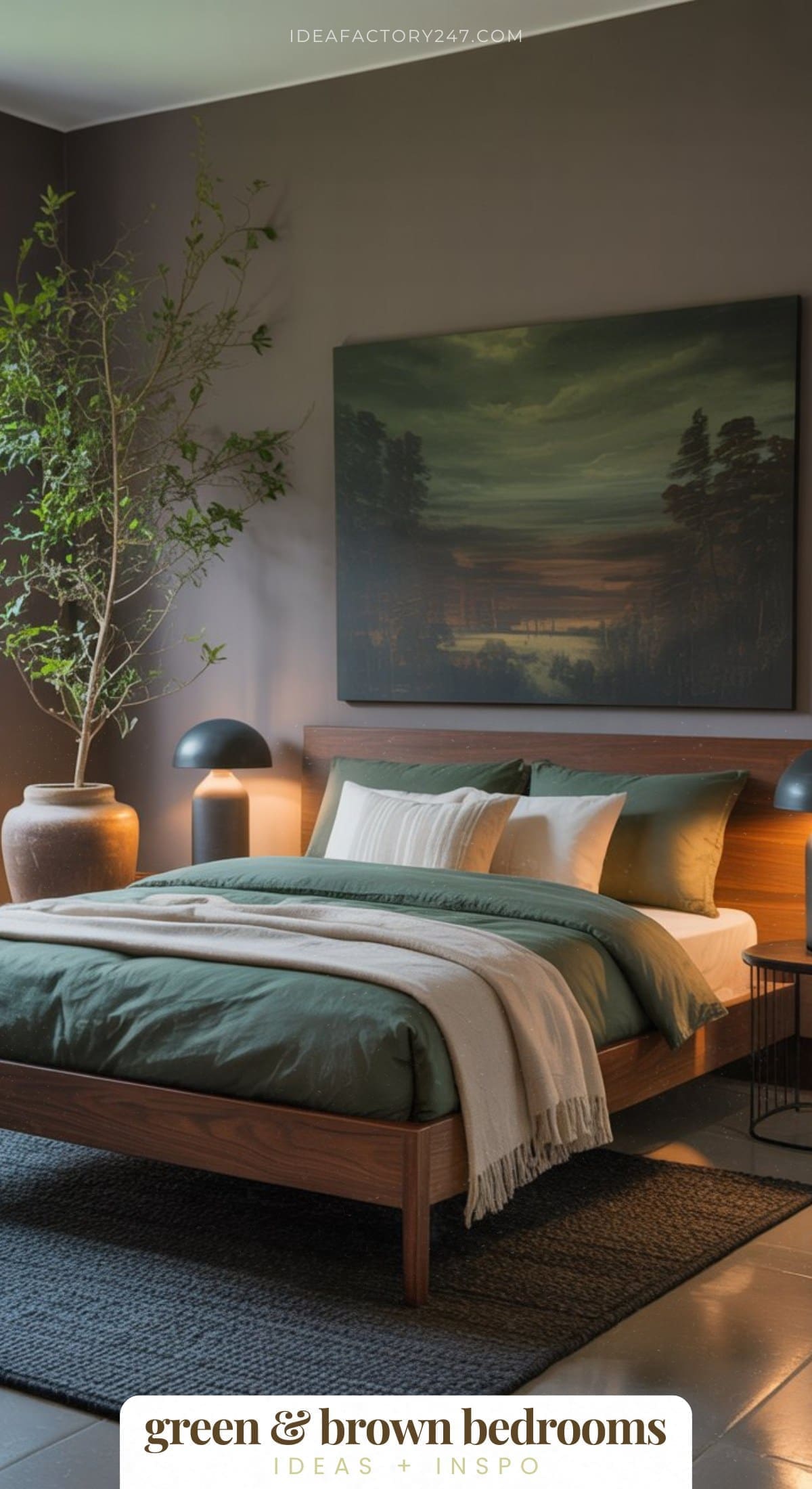 A modern bedroom with a wooden bed frame, green bedding, brown accents, a large potted plant, black lamps, and a landscape painting above the bed. The room has a cozy, earthy feel with natural decor elements.