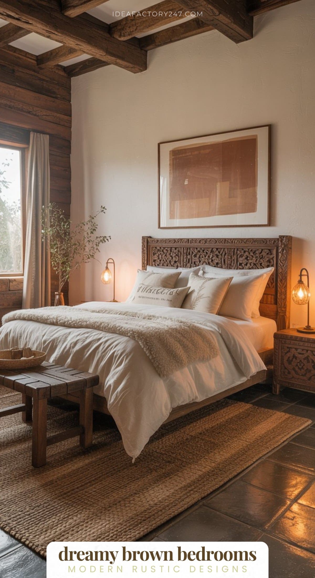 A cozy rustic bedroom with a carved wooden bed, neutral bedding, woven rug, wooden bench, and warm lighting. A large window lets in natural light and greenery sits in the corner. Text reads: dreamy brown bedrooms.