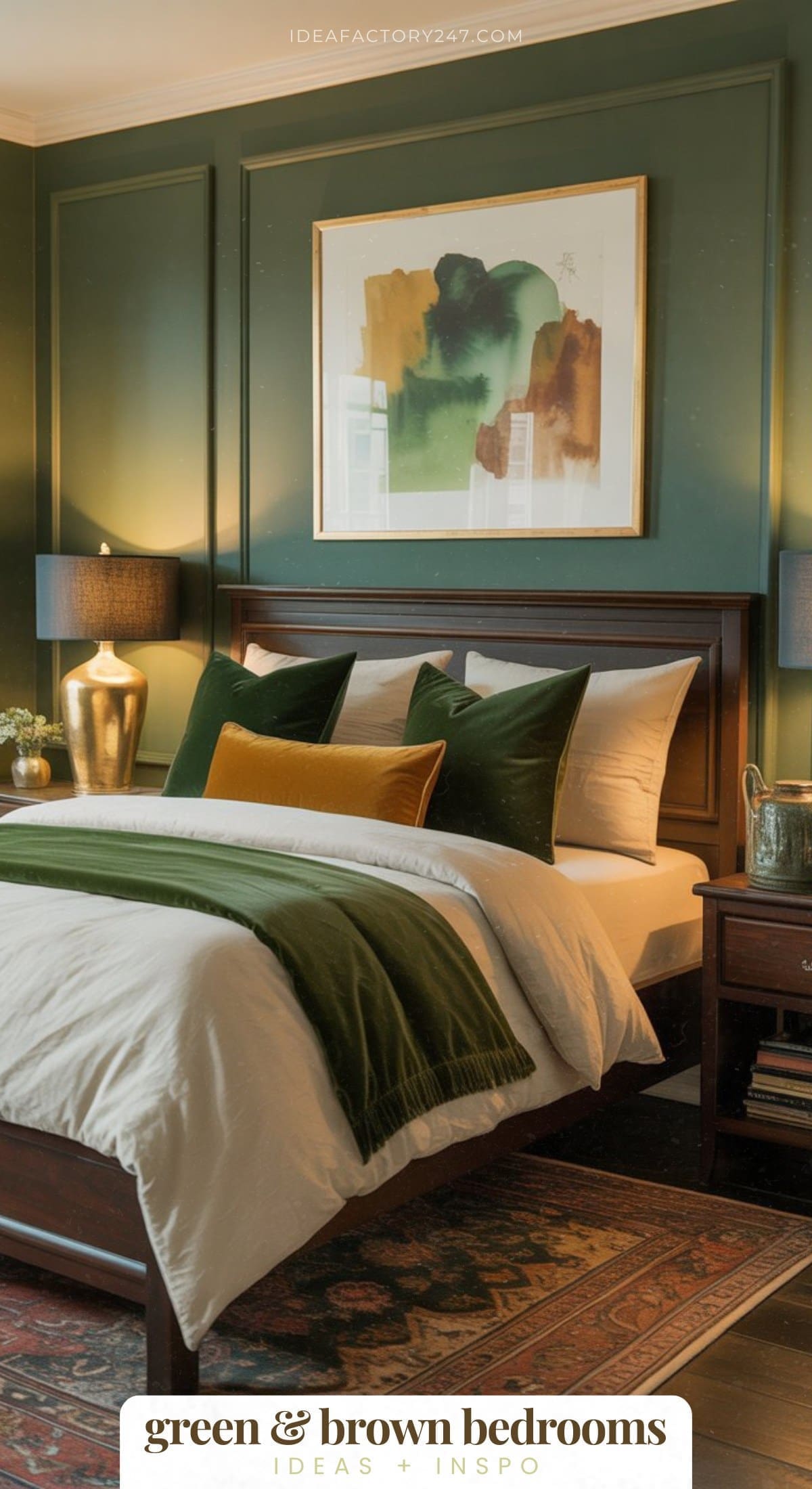 A cozy bedroom with green walls, a wooden bed with white bedding, green and mustard pillows, dark green throw, and two black lamps on bedside tables. Abstract art hangs above the bed. Rug and books complete the decor.