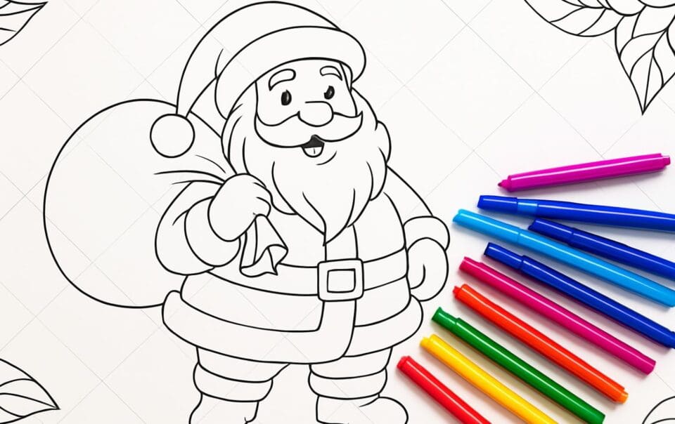 A black-and-white Christmas coloring page of Santa Claus holding a sack, with colorful markers arranged on the right side, ready for coloring. Leaf outlines are visible in the corners of the page.