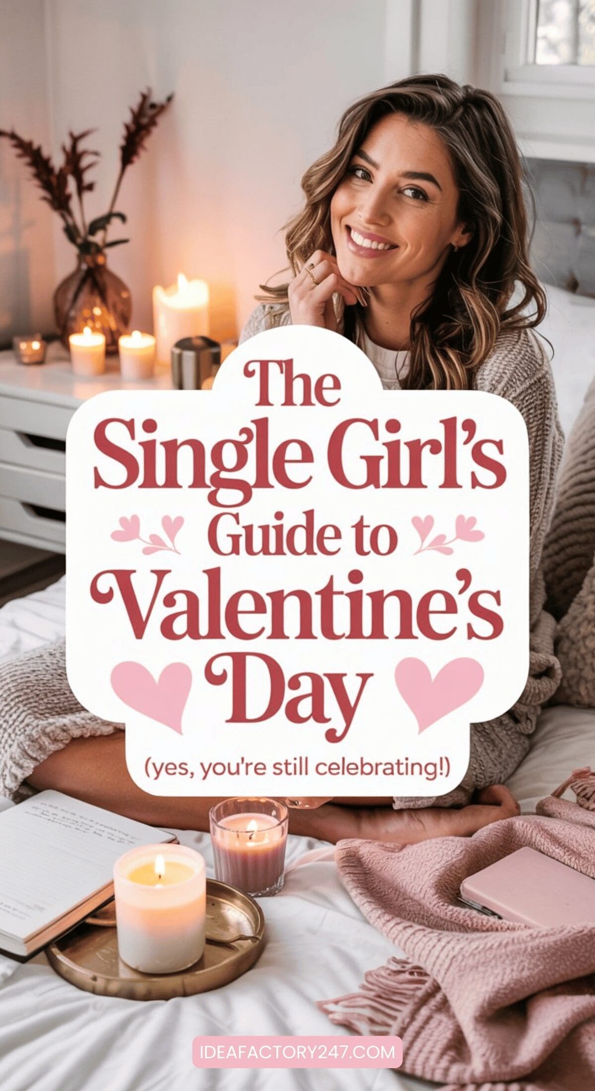A smiling woman sits on a cozy bed with candles, a book, and a mug nearby. Text overlay reads: The Single Girls Guide to Valentines Day (yes, youre still celebrating!). Soft, warm decor surrounds her.