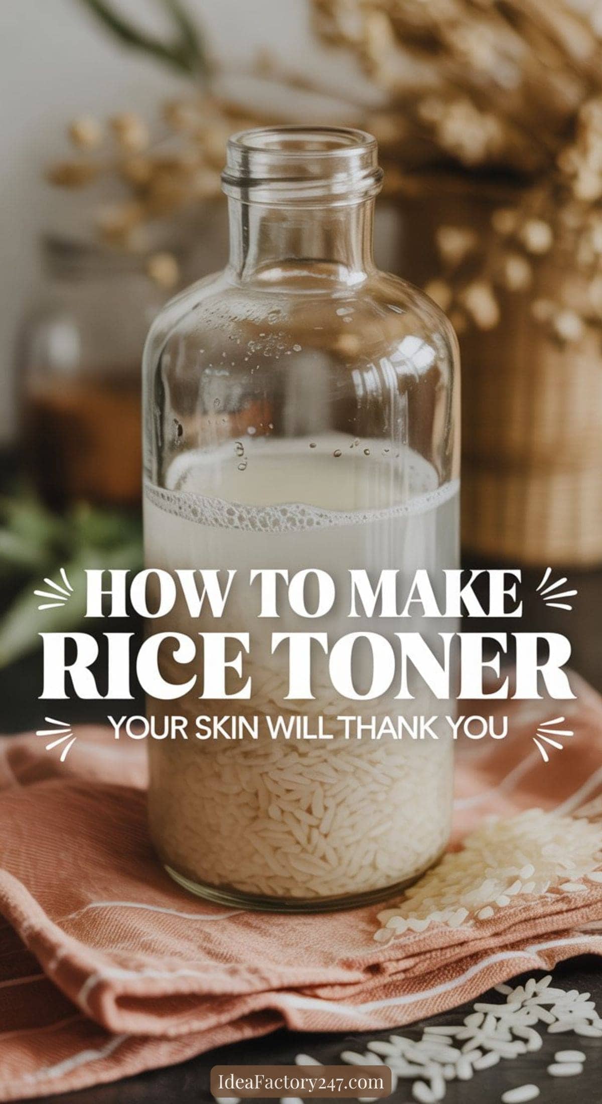 A glass bottle filled with rice water sits on a table surrounded by scattered rice. Text on the image reads: How to make rice toner. Your skin will thank you. A warm, natural setting is in the background.