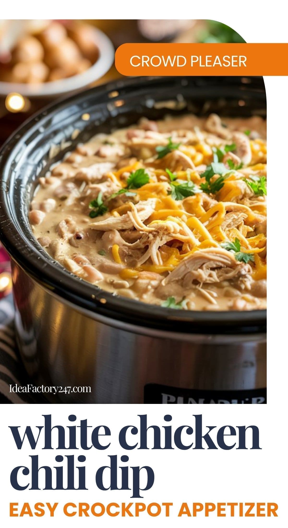 A crockpot filled with creamy crockpot white chicken chili dip, topped with shredded cheese and parsley. The image is labeled CROWD PLEASER and white chicken chili dip: easy crockpot appetizer.