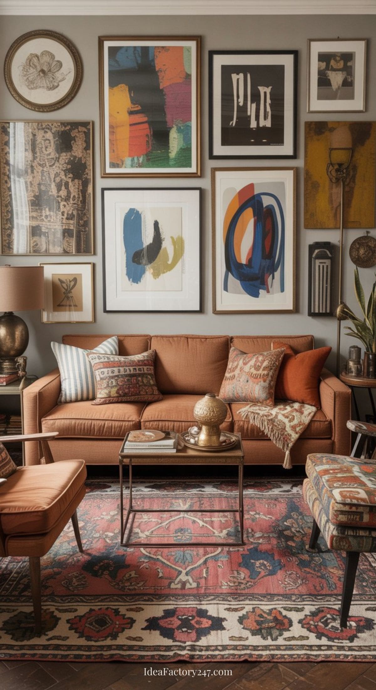 A cozy living room with an orange sofa, patterned pillows, matching armchair, and vintage-style rug. The wall behind is decorated with a gallery of colorful abstract art and framed prints. A coffee table and various decor accents complete the space.