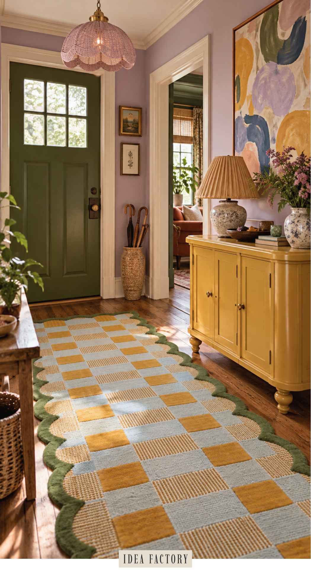 A colorful entryway featuring a hallway with a green front door, a yellow cabinet, and a blue and yellow checkered rug with scalloped green edges on the hardwood floor.