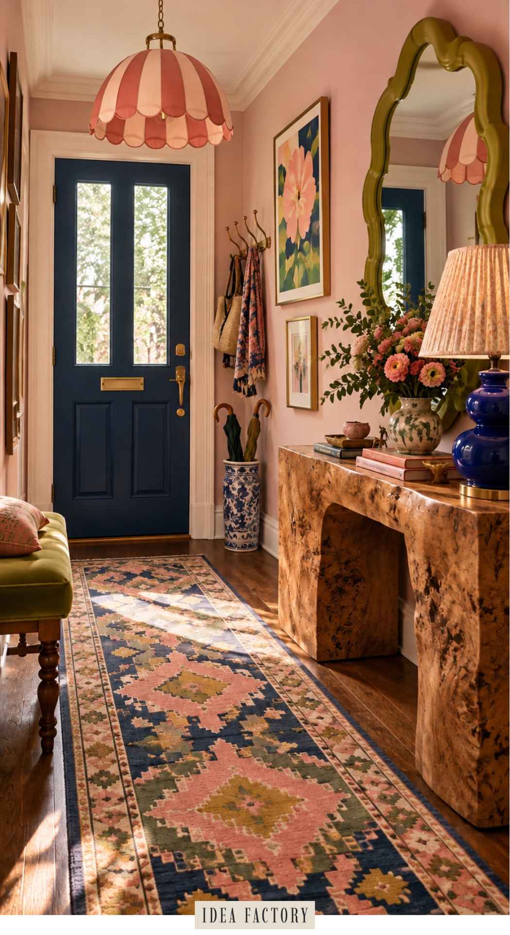 A colorful entryway featuring a blue front door, a patterned runner rug, and a rustic wooden console table holding a vase of flowers and a blue lamp.