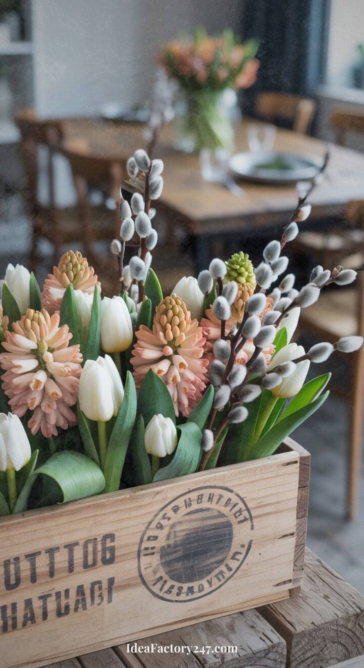 A wooden box with flowers and willows, perfect for cottage Easter centerpiece ideas.