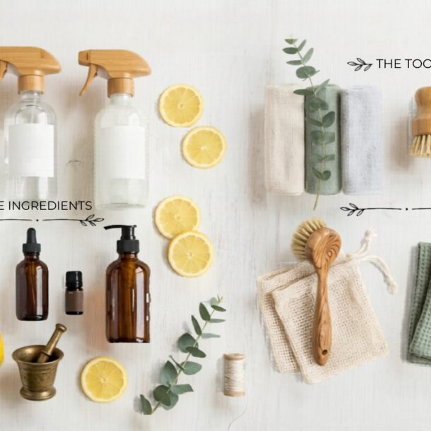 A flat lay of natural cleaning supplies: glass spray bottles, lemon halves, baking soda, essential oils, a lemon, eucalyptus leaves, and various brushes, cloths, and a soap dish—highlighting ingredients and tools for natural cleaning.