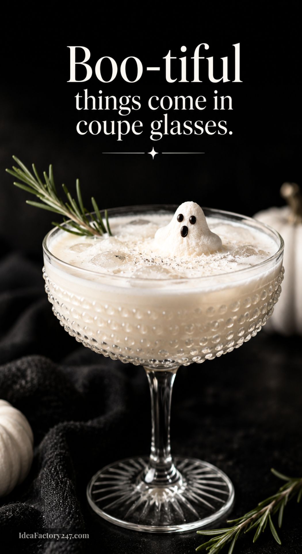 A creamy white cocktail in a coupe glass is garnished with a rosemary sprig and a ghost-shaped meringue. Text above reads, Boo-tiful things come in coupe glasses. A small white pumpkin sits in the background.