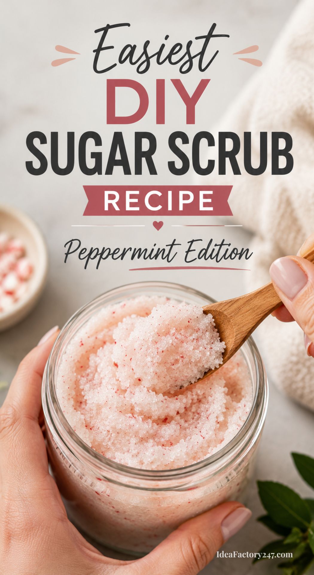 A hand scoops pink and white sugar scrub from a glass jar with a wooden spoon. Text reads: “Easiest DIY Sugar Scrub Recipe—Peppermint Edition.” A small bowl with scrub sits in the background.