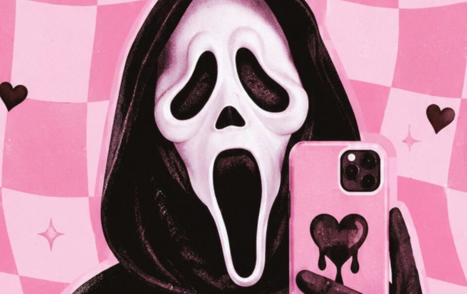 A person in a black hood wears a white “Scream” mask and holds a pink phone with a black heart on it, taking a selfie. The background is pink checkered with black hearts and sparkles.