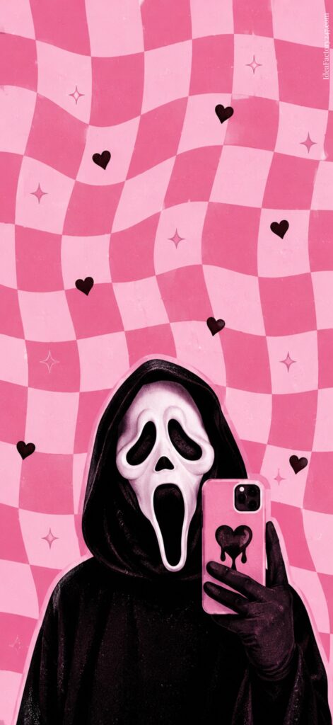 Person in a black hood and white Scream mask takes a selfie with a heart phone case. Pink wavy checkered background is decorated with hearts and sparkles.
