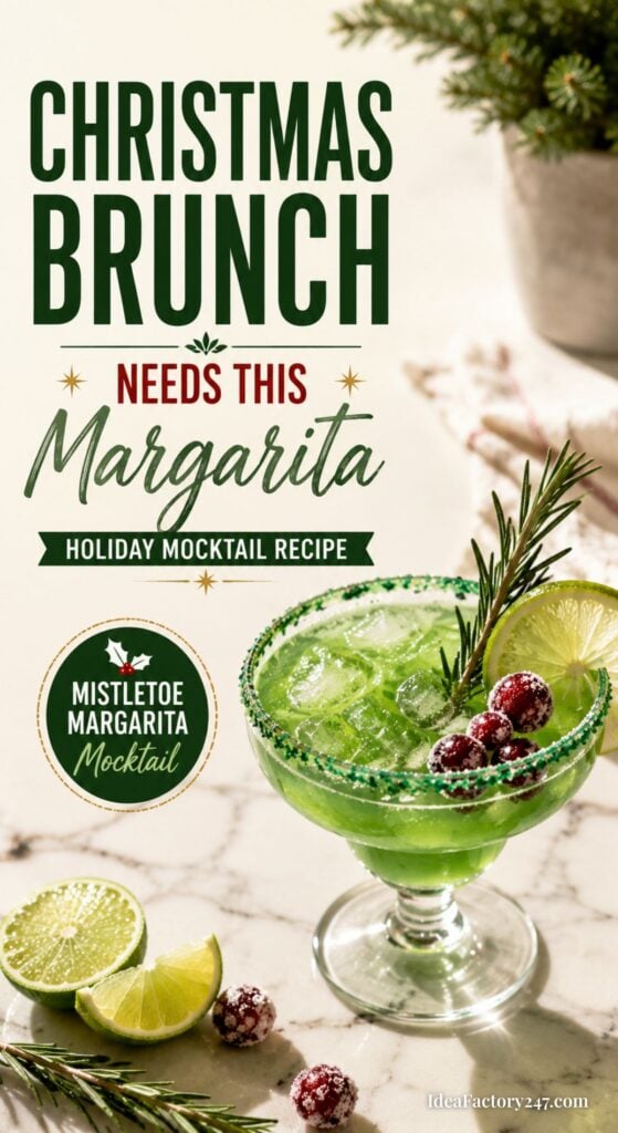 A festive green margarita mocktail in a glass with a sugared rim, garnished with rosemary and cranberries. Lime wedges and cranberries sit nearby. Text promotes a Christmas brunch margarita mocktail recipe.