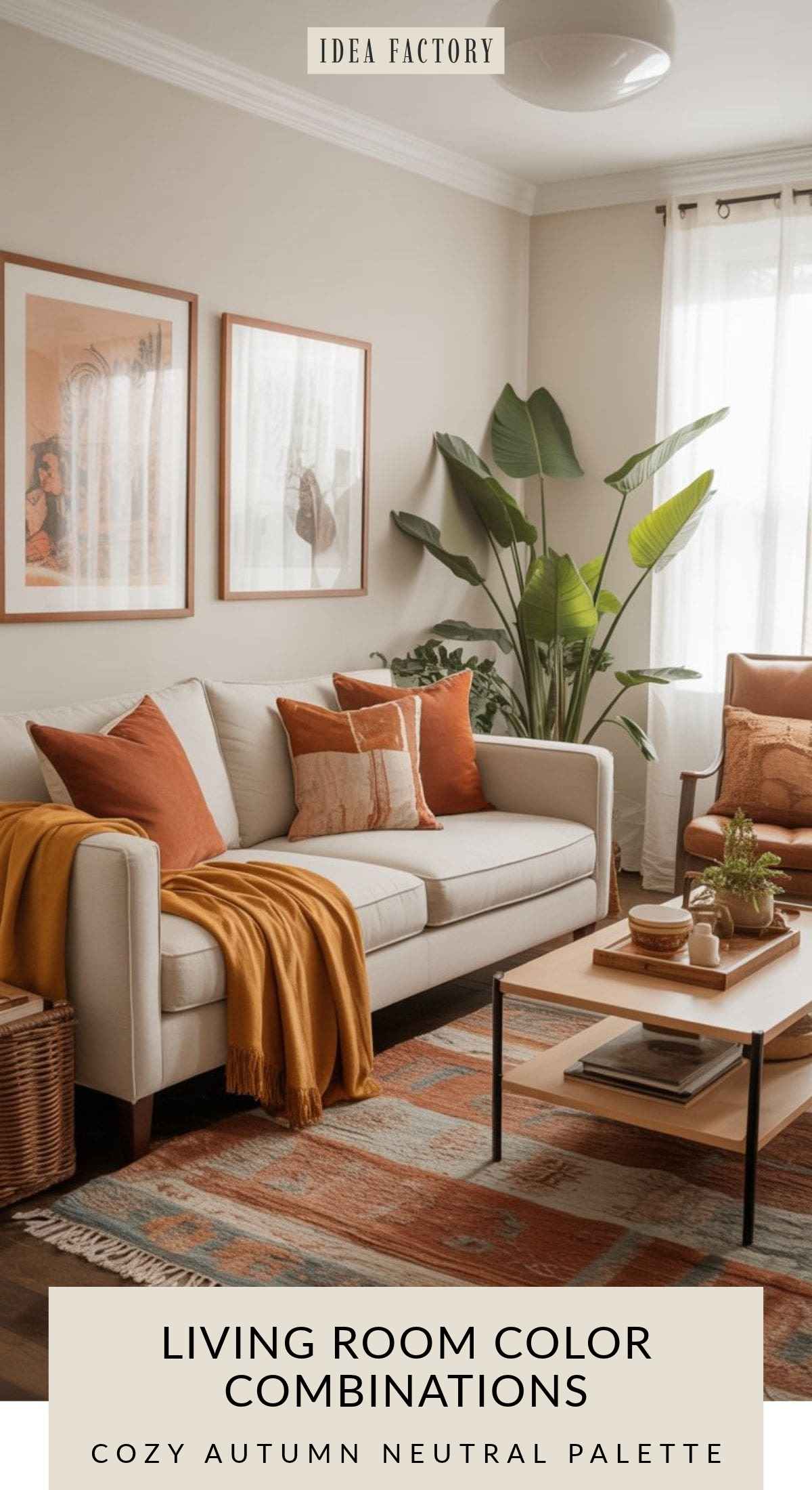 A neutral-toned living room featuring a cream sofa with orange and gold throw pillows and blankets, a patterned area rug, a potted plant, and a wooden coffee table.
