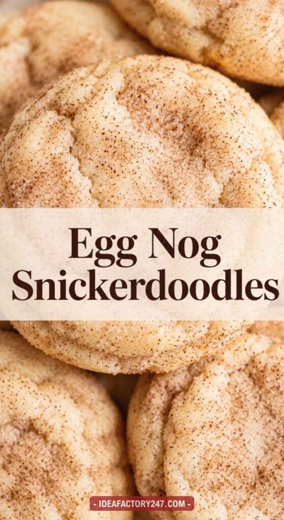 Close-up of several golden-brown snickerdoodle cookies dusted with cinnamon sugar. Text overlay in the center reads Egg Nog Snickerdoodles. Website URL appears at the bottom.