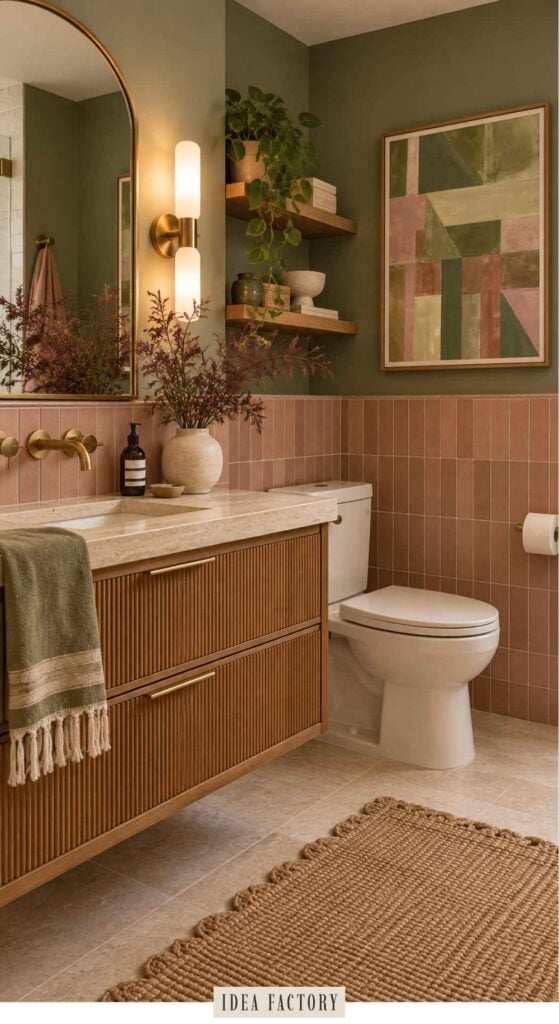 Modern bathroom with a ribbed wood vanity, pink vertical tiled walls, an arched mirror, and floating shelves with plants.