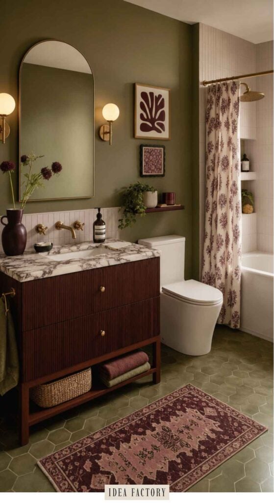 Bathroom with olive green walls, a marble-topped wooden vanity, an arched mirror, and a floral shower curtain.